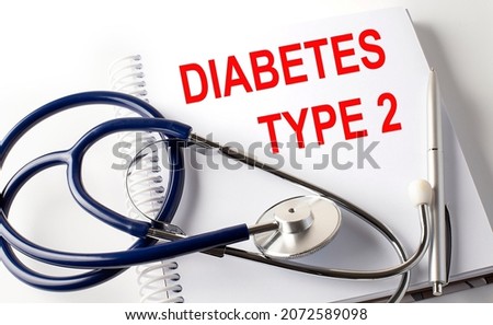 Notebook with text DIABETES TYPE 2 with pen and stethoscope