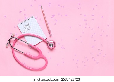 Notebook with text GOALS HEALTH and stethoscope on pink background - Powered by Shutterstock