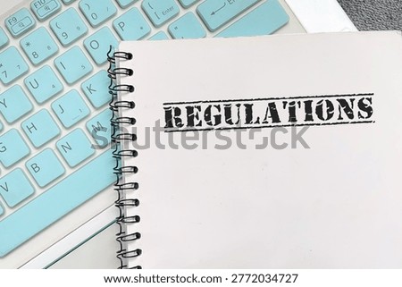 Notebook with text Regulation. Concept of rules, compliance, governance, and corporate control.