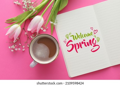 Notebook with text WELCOME SPRING, beautiful flowers and cup of coffee on pink background