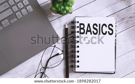 Notebook with Tools and Notes with text BASICS business