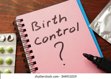 Notebook with the words Birth control  on the table.