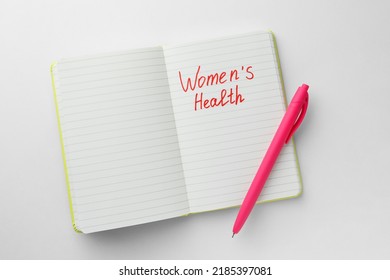 Notebook With Words Women's Health And Pen On White Background, Top View