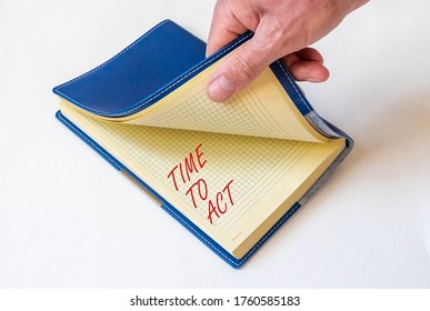 notebook written time to act over white background with male hand. time to act motivation concept