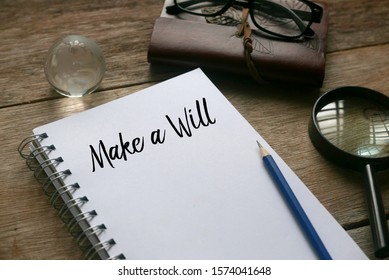 Notebook,glasses,magnifying Glass,pencil And Notebook Written With Make A Will On Wooden Background.