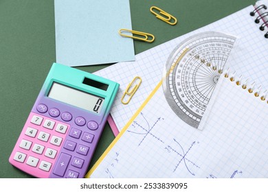 Notebooks with calculator and school stationery on chalkboard - Powered by Shutterstock