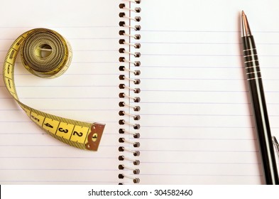 Notepad with centimeter and pen