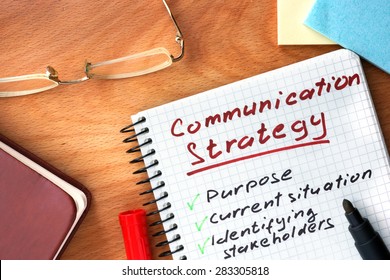 Notepad With  Communication Strategy Concept On A Wooden Board.
