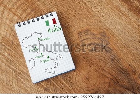 Notepad with the design of the boot of Italy and the names of 4 of the most well-known tourist cities: Rome, Naples, Florence, Venice