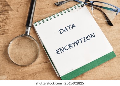 Notepad displaying the phrase data encryption alongside a magnifying glass and glasses on a wooden surface emphasizes the importance of encryption in technology and cybersecurity. - Powered by Shutterstock - Get 15% off with code: PIKWIZARD15