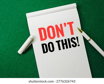 Notepad with Dont Do This Text in Red and Black with White Pen on Green Background Concept of Warning Advice Mistake Prevention and Awareness. 