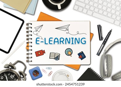 Notepad with e-learning word, digital tablet, headphone and stationery on white background