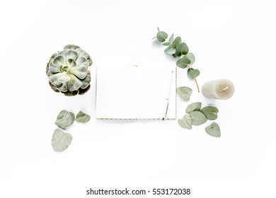 Notepad, Eucalyptus Green Succulent, Candle, Leaves Isolated On White Background. Flat Lay, Overhead View