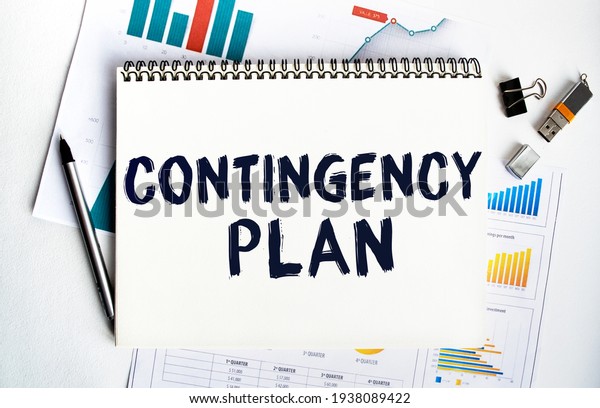 Notepad with the inscription\
CONTINGENCY PLAN. Conceptual image, business accessories,\
calculator isolated on the desktop. Finance or business\
concept.