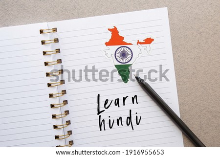 notepad with the inscription learn hindi, india flag and country map, pen, foreign language learning concept