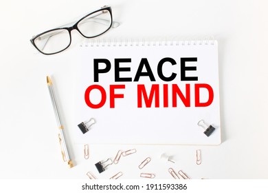 Notepad With Inscriptions PEACE OF MIND On A White Background. Business Concept.