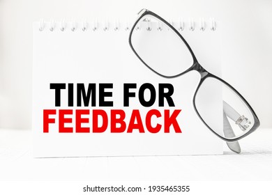 Notepad with inscriptions TIME FOR FEEDBACK on a white background. business concept.