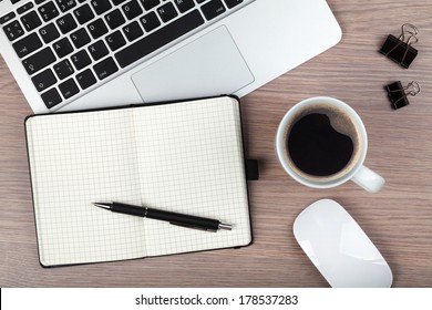 Notepad, Laptop And Coffee Cup On Wood Table. View From Above