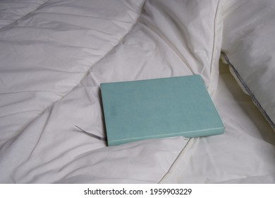 Notepad On The Bed. Interior. Mockap. White Bedding.