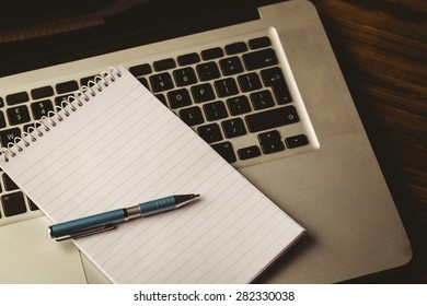 Notepad On Laptop On A Desk