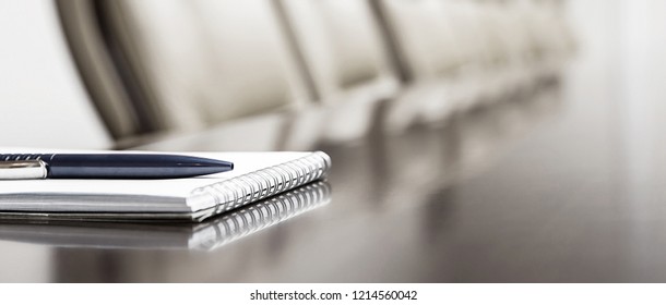 notepad on a table in meeting room - Shutterstock ID 1214560042