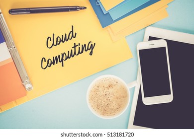 Notepad on workplace table and written CLOUD COMPUTING concept