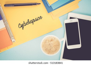 Notepad on workplace table and written CYBERSPACE concept