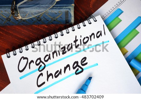 Notepad with Organizational Change on a wooden surface.