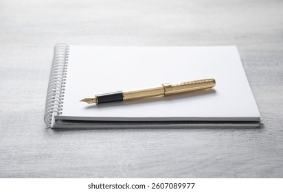 Notepad, pen, with a different business objects on the table.