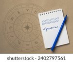 Notepad with pen and drawing of zodiac sign Aquarius