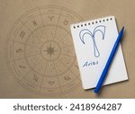 Notepad with pen and drawing of zodiac sign Aries