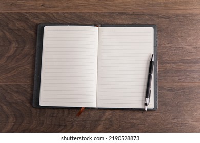 notepad with pen on working table
