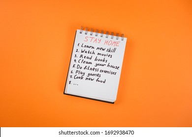 Notepad With Stay Home Check List On Covid 19 Quarantine. Stay Home, Stay Safe. Read Books, Play Games, Watch Movies, Learn New Skill, Clean Your House, Do Fitness, Cook New Meal. 