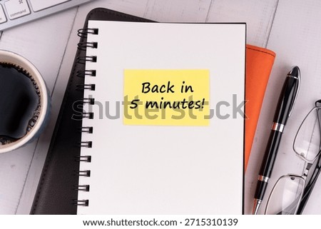 Notepad with text back in five minute