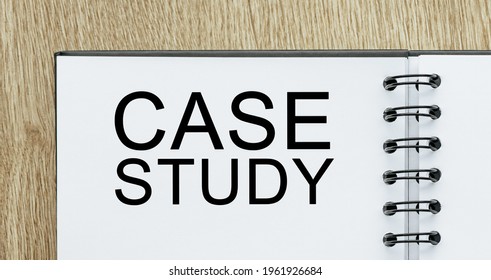 Notepad with text Case Study on wooden deskt. Business and finance concept