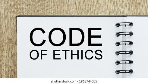 Notepad With Text Code Of Ethics On Wooden Deskt. Business And Finance Concept