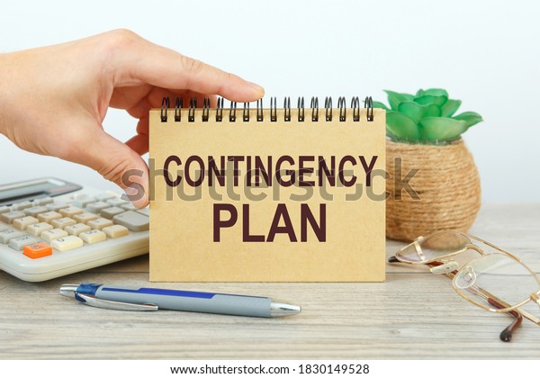 Notepad with text\
Contingency Plan on a white background, near calculator and office\
supplies. Business\
concept.