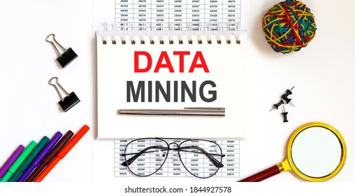 Notepad With The Text Data Mining On Light Background, Near Glasses And Office Tools