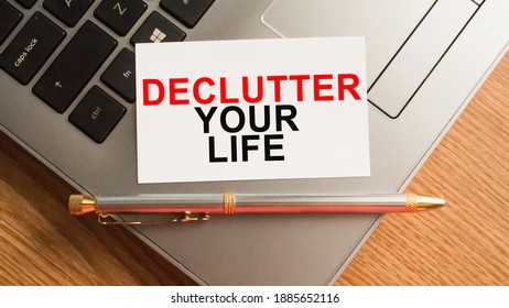 Notepad With The Text DECLUTTER YOUR LIFE Is On The Laptop Keyboard. Minimal Work Space. Business Concept.