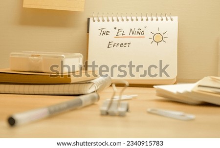 Notepad with the text the El Nino effect and hand drawing sun on desk. Climate change concept. 