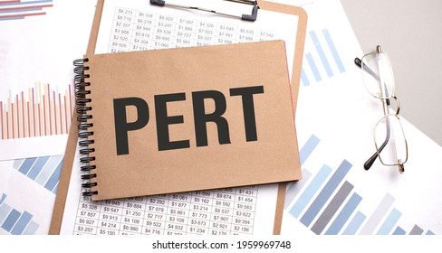Notepad with text pert on a charts and numbers. Business concept.