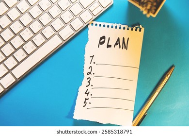 notepad with text plan and keyboard on the table.