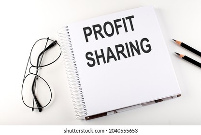 Notepad With Text PROFIT SHARING . White Background. Business