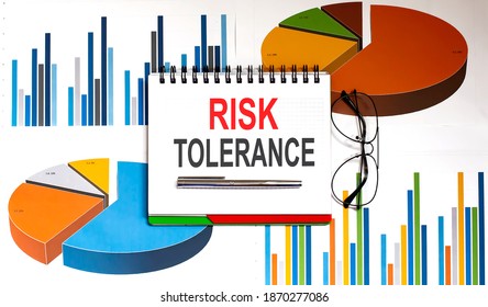 Notepad With Text Risk Tolerance On Business Charts And Pen And Charts