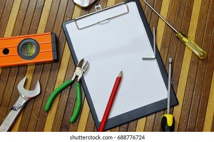 Notepad with various type of tools. Industrial construction work concept. Copy space for text and word