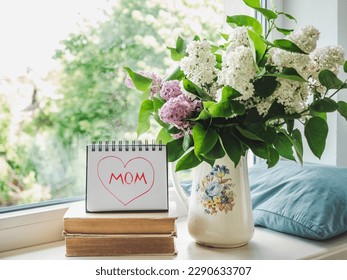 Notepad with the word MOM. Closeup, indoors. Congratulations for family, loved ones, friends and colleagues - Powered by Shutterstock