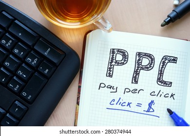 Notepad with words PPC pay per click  concept and marker.