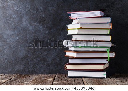 Notepads on table in front of chalk board. Back to school concept with copy space