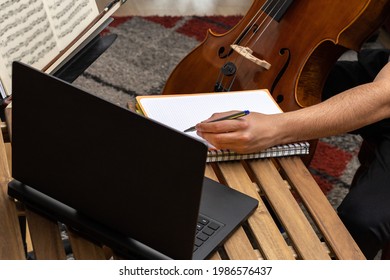 Notes In A Notebook In The Middle Of An Online Music Class With The Laptop And The Cello During Confinement Time Concept Online Classes