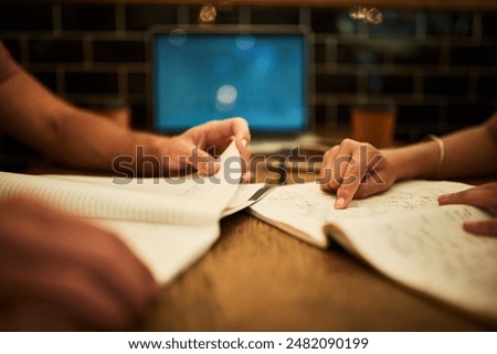 Notes, student and studying with tutor, hands and reading of book for exam in library of college. Closeup, people and help for project on literature in university, campus and knowledge of education